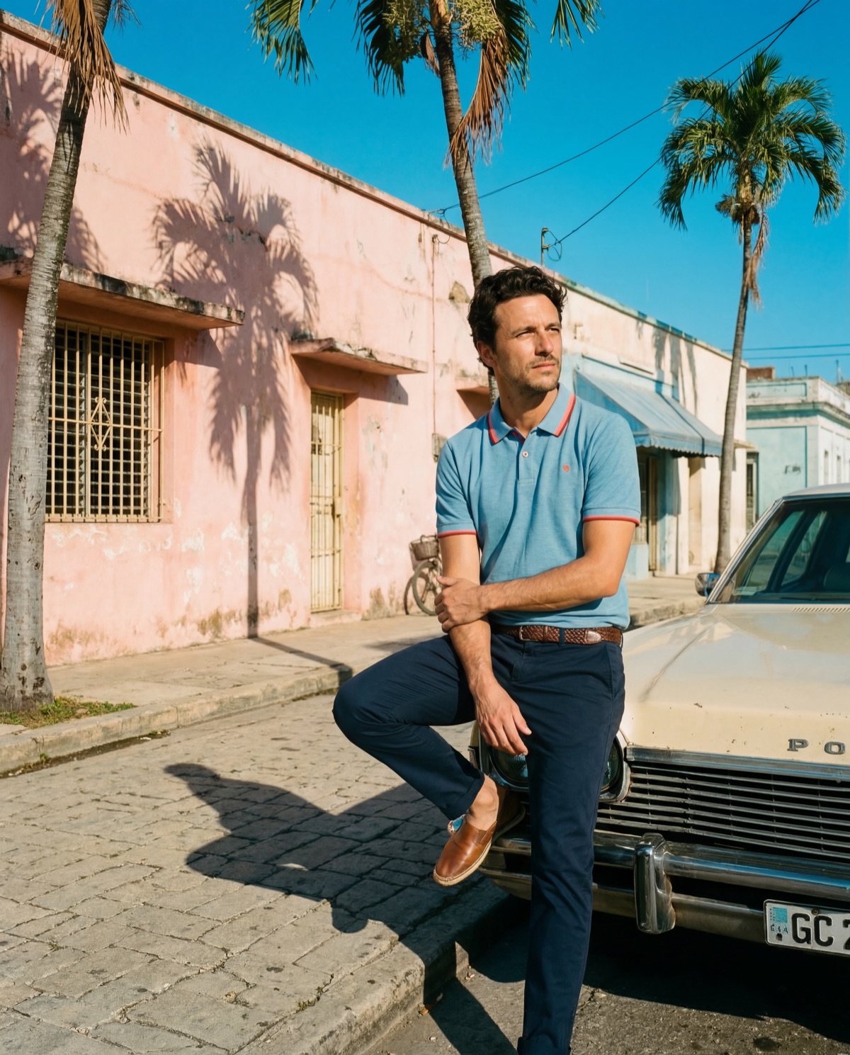 Man leaning on car in blue polo — street editorial