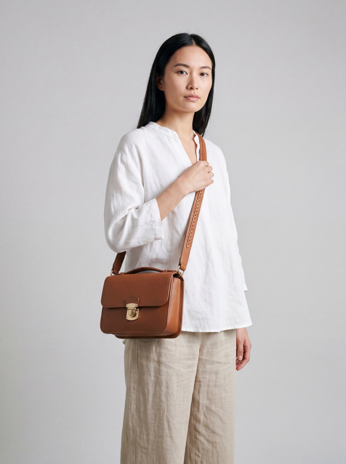 Model wearing leather bag