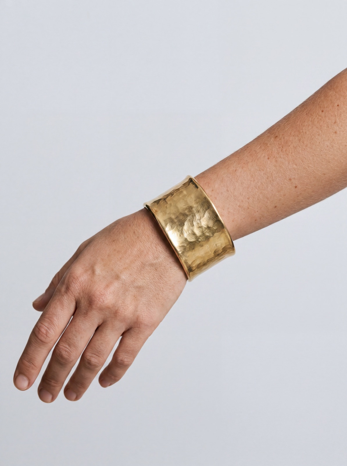 Gold bracelet worn — close-up