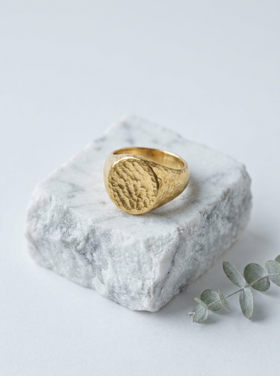 Gold signet ring on marble